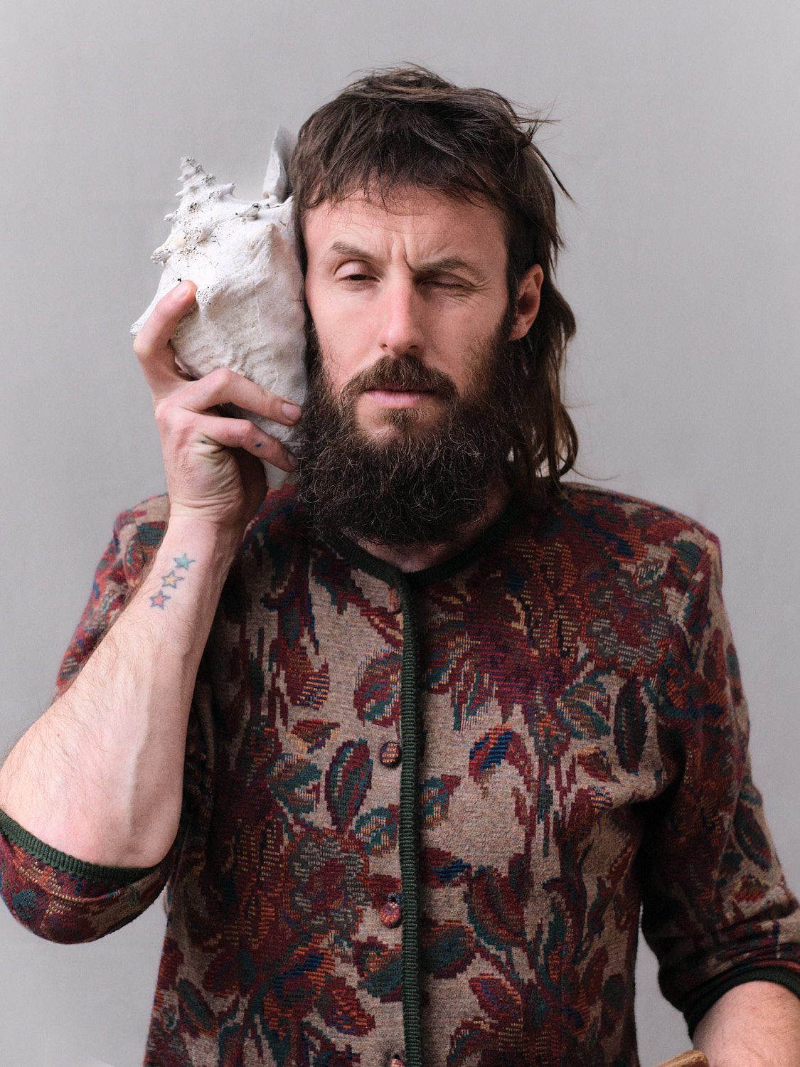 Artistic portrait of Thomas Schrenk with a shell photographed by Sandra Schwaiger working between Vienna and Berlin – photography by Sandra Schwaiger
